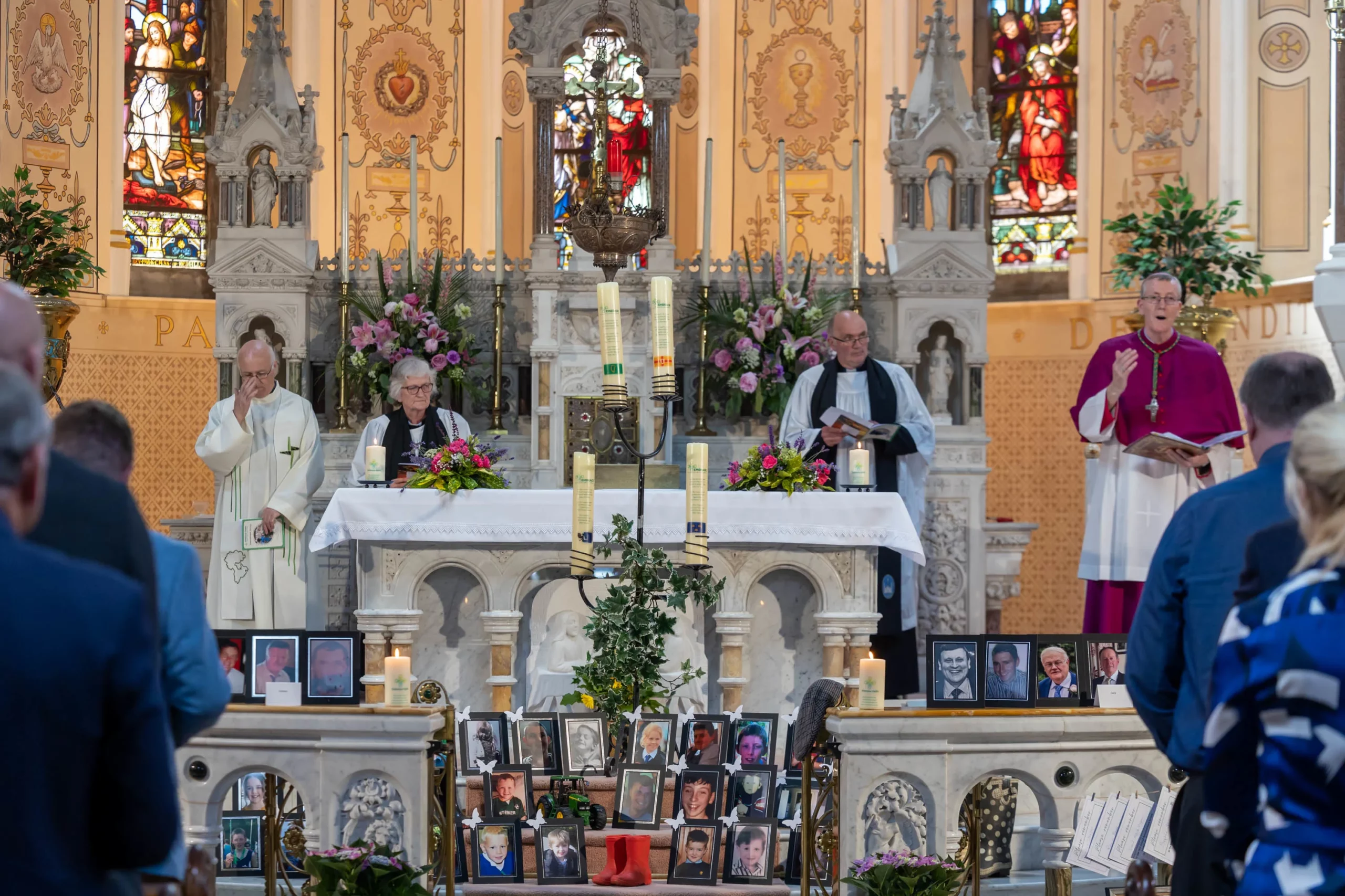 Priests leading a memorial service in a beautifully decorated church
