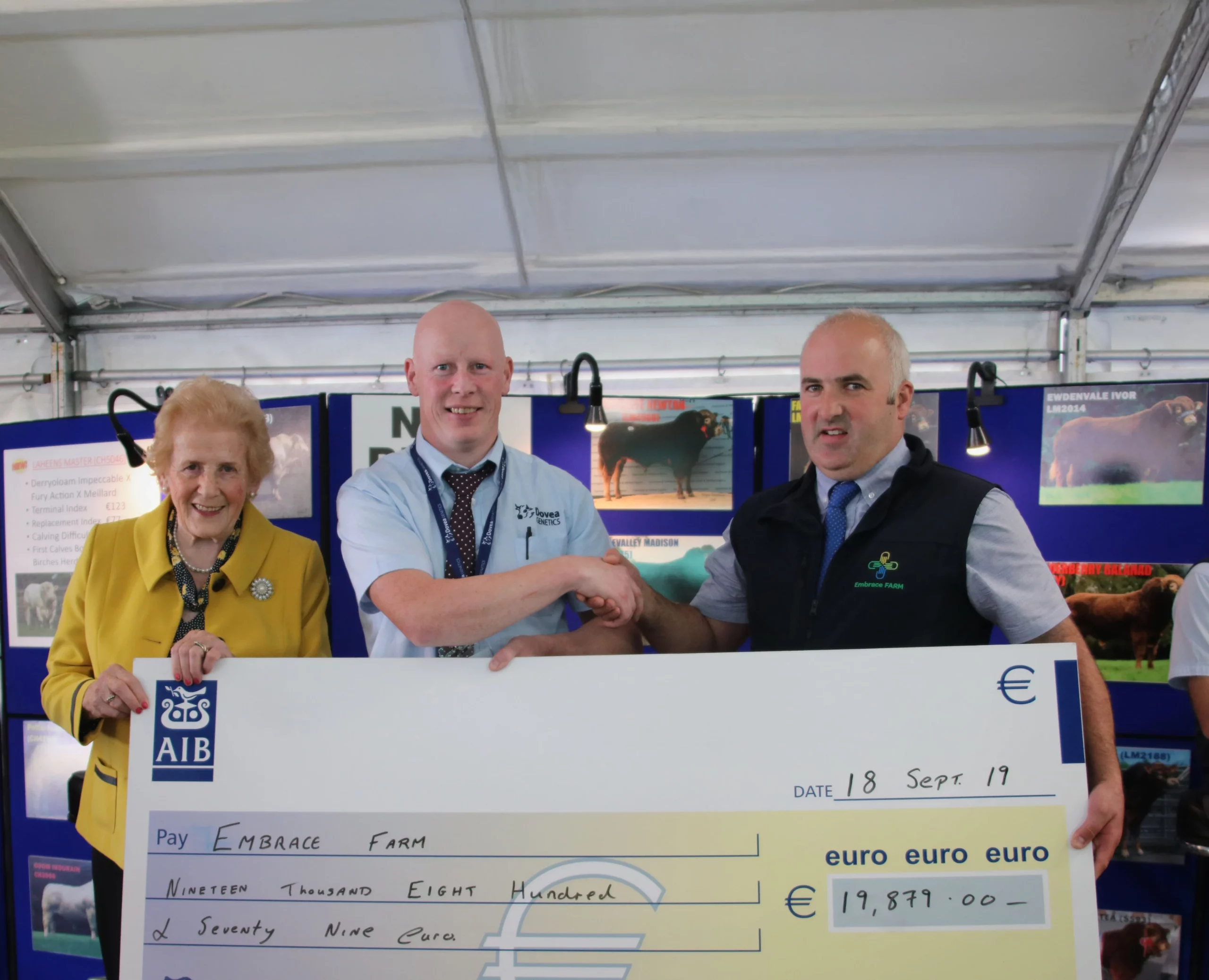 Presentation of a large donation check to Embrace Farm